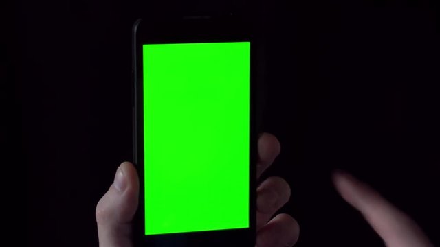 Close-up of male hands touching of smartphone. Green screen Chroma Key. Close up. Tracking motion.