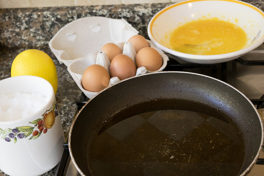 preparing a frittata with beaten eggs and pan