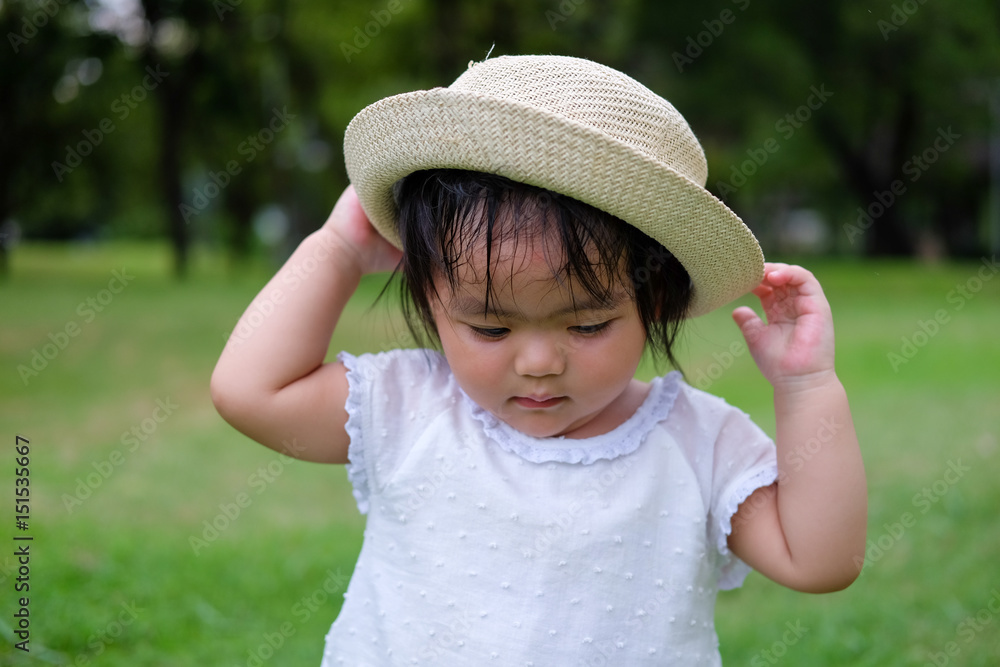 Wall mural cute baby girl playing in the garden, close-up portrait, portrait of asian beautiful baby girl of 1 