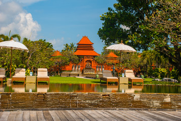 Beautiful Balinese building with a fountain and sculpture-man playing the flute. Tanjung Benoa....