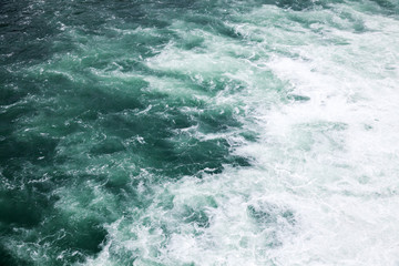Fototapeta na wymiar Stormy sea, deep blue water with foam