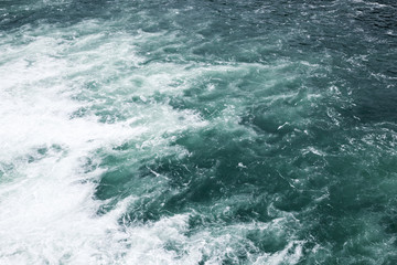 Fototapeta na wymiar Stormy sea, waving deep blue water surface