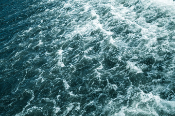 Fototapeta na wymiar Stormy sea, deep blue water surface with foam
