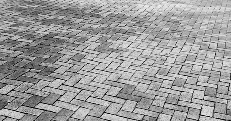 Naklejka premium Gray cobblestone road pavement texture
