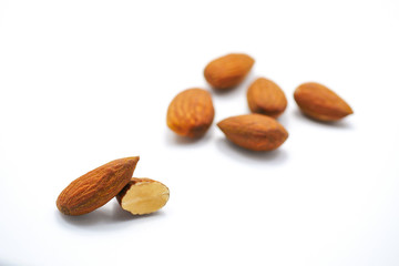 Group of roast almonds isolated on white background