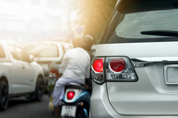 Car stop on the road by traffic jam in city.
