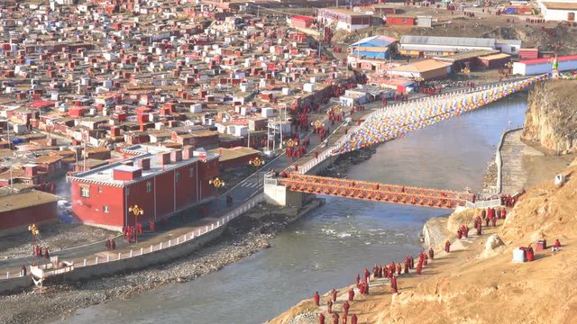 Buddhist monks and nuns walking from Yarchen Gar Monastery in the morning to the place of worship