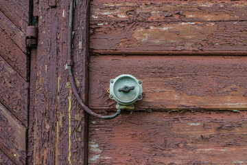 Dark wooden wall with control switch and wire