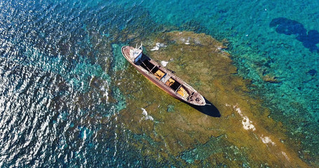  Beautiful seascape with old big, broken, rusty boat near the coast of Peyia, Cyprus. Ship graveyard. Famous landmark in the Mediterranean sea.