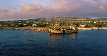  Beautiful seascape with old big, broken, rusty boat near the coast of Peyia, Cyprus. Ship graveyard. Famous landmark in the Mediterranean sea.