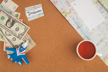 Fototapeta na wymiar Travel accessories . Preparation for travel, money, note, mug, map on wooden table, toy airplan, trip concept, copy space