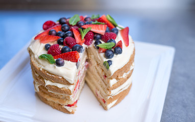 Delicious raspberry cake with fresh strawberries, raspberries, blueberry, currants 