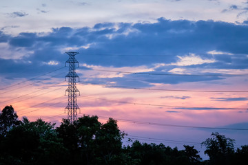 Silhouette electricity post with beautiful sunset background.