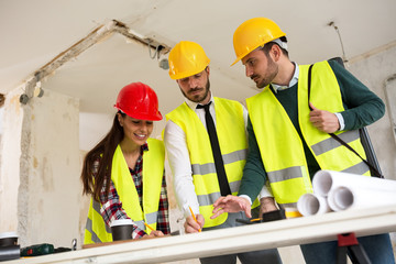 Three arhitects working together on construction site project