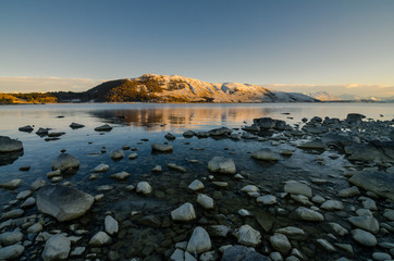 Beautiful morning at Lake Tekapo. Amazing view with the morning sun light shine on the snow capped mountain.