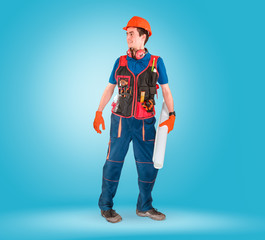 Handsome young handyman with a tool belt looking on a left. House renovation service. Building concept.