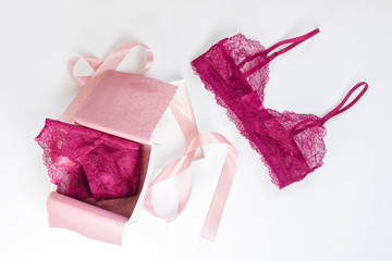 Shopping and fashion, female wardrobe concept. Set of glamorous stylish sexy lace lingerie in pink giftbox on white background. Woman accessories.