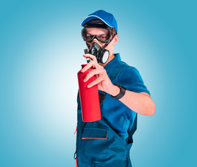 Building painter in protective mask and glasses on a blue background. Painting concept.