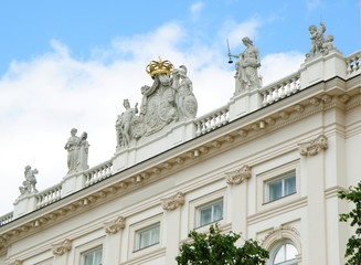 Fototapeta na wymiar Stunning facade with many beautiful sculptures of a white building in Vienna, Austria 