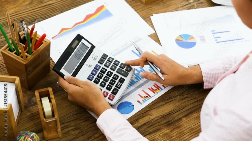 Poster businesswoman using calculator while analyzing the graph