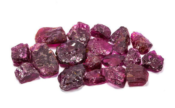 Pile of raw natural ruby on white background