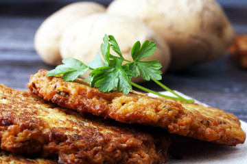 potato pancakes decorated with parsley on a cutting board on the table