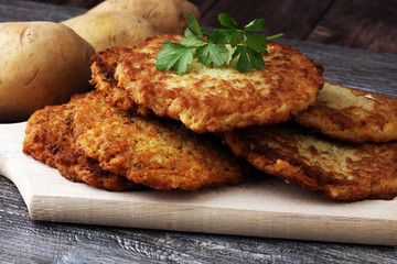 potato pancakes decorated with parsley on a cutting board on the table