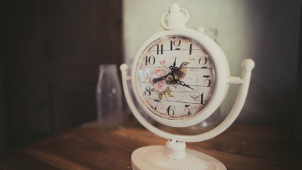 White alarm clock on table