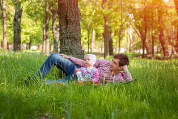 Fototapeta premium Young father with baby outdoors in park
