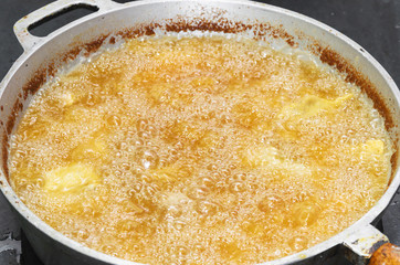 Frying food in a pan with hot and boiling oil