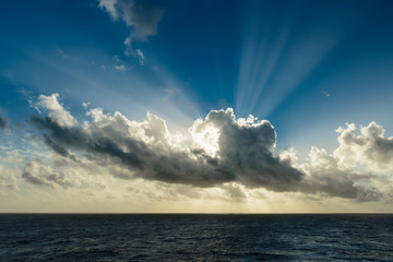 Sunset in ocean: dramatic clouds