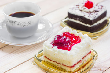 Cake with chocolate and strawberry cake on wood background.