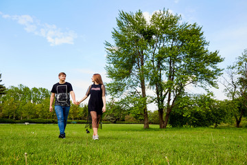 A loving couple walks in the park.