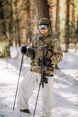 ranger with rifle in cold forest. Winter warfare and military concept
