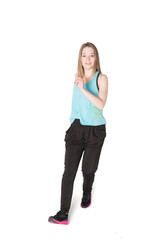 Young, pretty natural looking girl in sport t -shirt and jogging pants having fun dancing. Full body studio shot, pure white background.