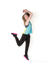 Young, pretty natural looking girl in sport t -shirt and jogging pants having fun dancing. Full body studio shot, pure white background.