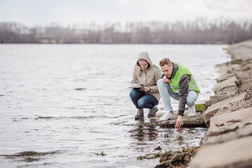 Scientists or biologists working together on water analysis. .