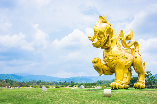 big singa gold color in park blue sky