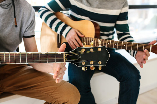 Learning to play the guitar. Music education.