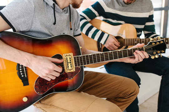 Learning to play the guitar. Music education.