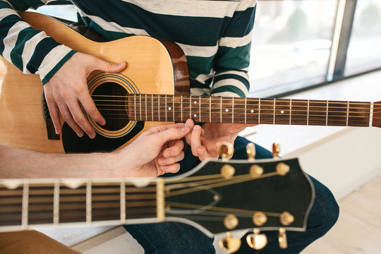 Learning to play the guitar. Music education.