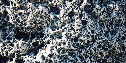 Magma background. Toned photo. Wide format. Porous rock texture. Black and white foamypumice. Foamy stone texture. Closeup shot of lava stone. Walking Lycian Way, Turkey.