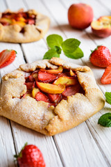 Traditional French Galette pie filled with strawberry and peach