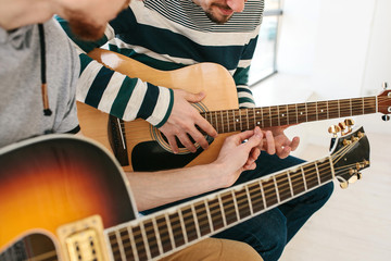 Learning to play the guitar. Music education.
