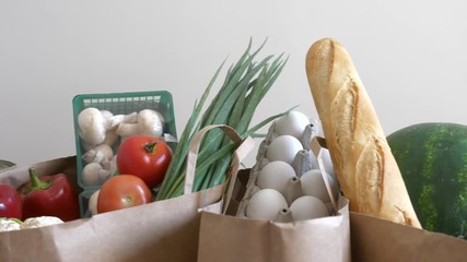 Groceries paper bags filled with variety of fresh consumer products