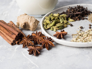 Ingredients for masala tea - milk, cinnamon, cardamom, anise, fennel, ginger, black tea, star...