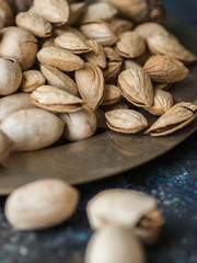 Almonds in shell on metal plate. Selective focus

