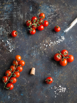Tomatoes and salt on dark rustic background

