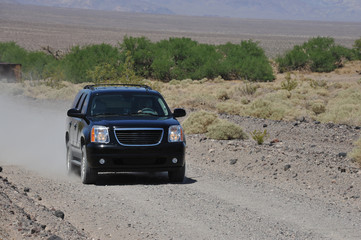 Obraz na płótnie Canvas A high performance SUV being driven flat out on a track in Death Valley, America.