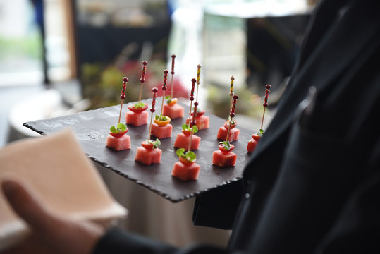 Waiter holding tray with canapes